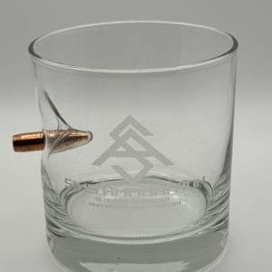 ms Ammunition – High-Quality Ammunition for Rifles and Shotguns" The BenShot 11oz Rocks Glass with 308 Bullet and SA Logo is a clear glass embedded with a copper bullet on the side, simulating the effect of high-quality ammo passing through. The glass features a logo and silver text. This unique design highlights elements associated with ammunition, including rifle cartridges and shotgun shells, making it an appealing choice for enthusiasts who appreciate bulk ammunition displays. Bulk Ammo Available for Purchase"